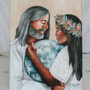 Man and woman of color wearing white clothing holding earth between them