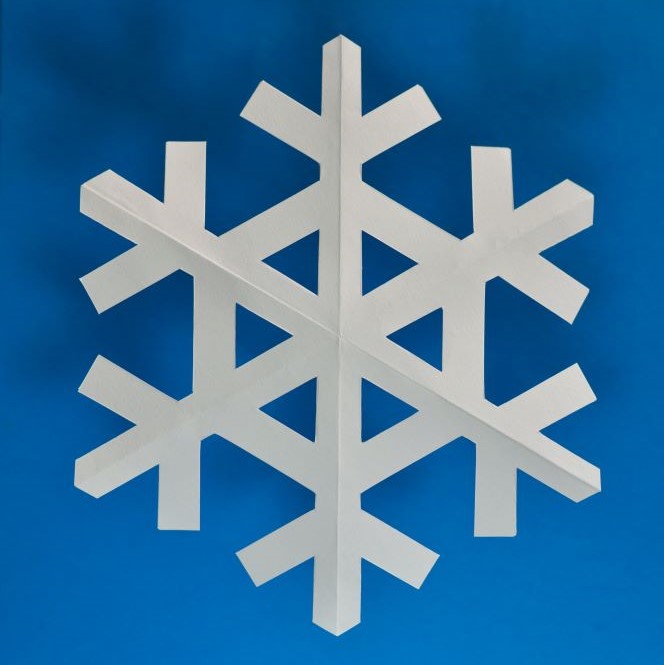 White paper snowflake on blue background