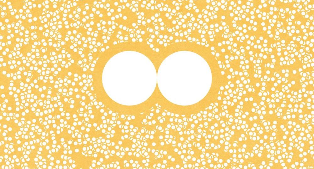 Two white circles surrounded by many tiny circles on a yellow background